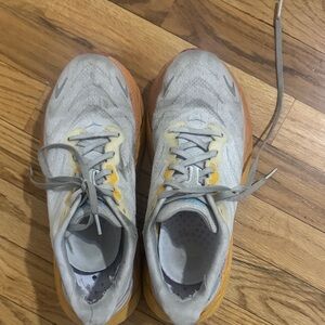Worn Hoka Gray and Yellow Running Shoes